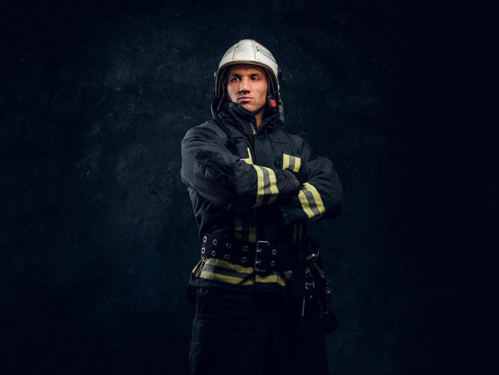 portrait-fireman-uniform-helmet-stands-with-crossed-hands-looking-sideways-with-confident-look-studio-photo-against-dark-textured-wall (1) (1).jpg